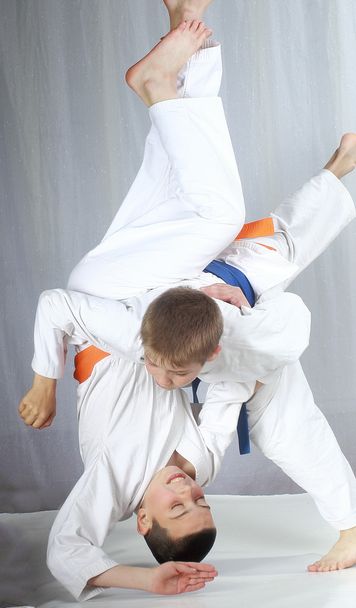 An athlete with a blue belt performs technique nage-waza - Photo, Image