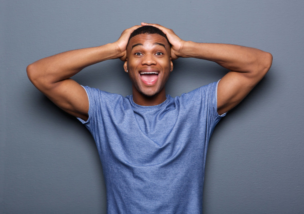 Young man with surprised expression on face - Fotoğraf, Görsel