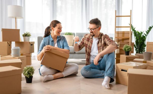 Happy young married couple are moving to new apartment. - Φωτογραφία, εικόνα