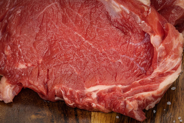 raw beef meat on a wooden board - 写真・画像