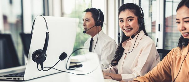 Business team wearing headset working actively in office - Photo, Image
