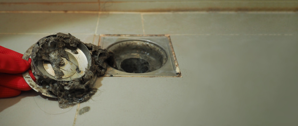 Drain cleaning. Clogged and dirty sewer pipes floor drain. Full of hair and accumulated clogged grease. Maintenance the floor drain sewage system in bathroom. fixing clean wash and unclog a drain. - Photo, Image