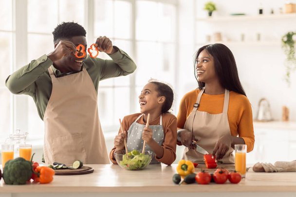 Black Family Having Fun With Vegetables While Cooking In Kitchen - Фото, зображення
