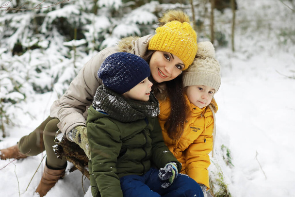 Glückliche Familie spielt und lacht im Winter draußen im Schnee. Wintertag im Stadtpark. - Foto, Bild