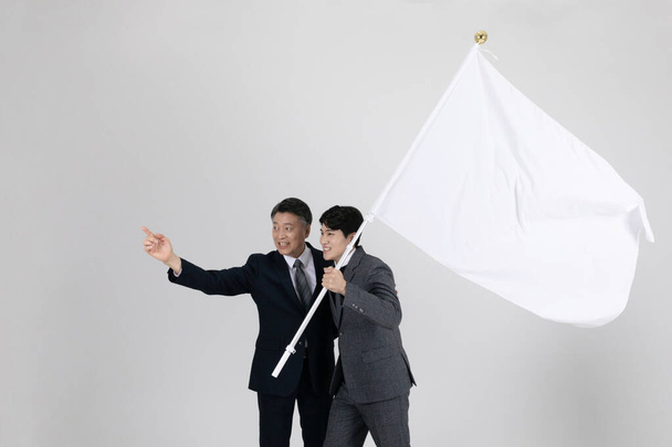 business concept Korean Asian old and young men holding a big flag - Fotó, kép