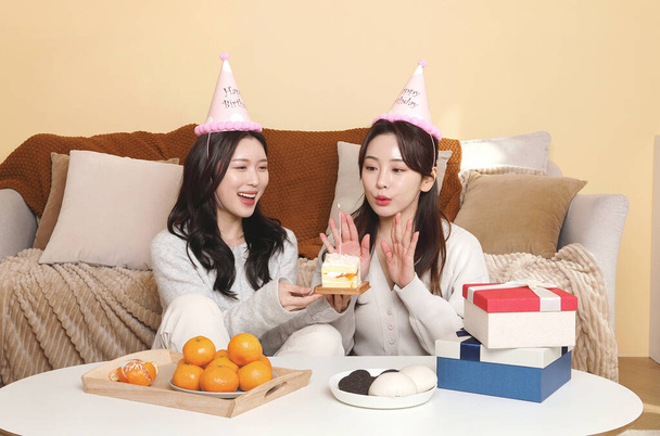 asian korean women best friends celebrating birthday, blowing cake candles - Photo, Image
