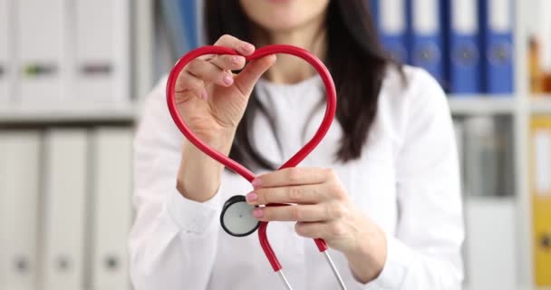 Lekarz robi emblemat serca ze stetoskopu. - Materiał filmowy, wideo