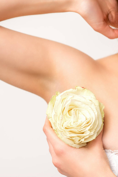 Close up of female armpit with white rose flower isolated on white background - Photo, Image