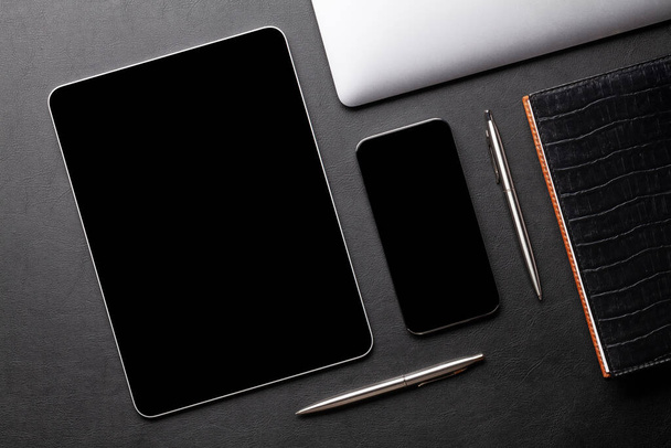 Tablet and smartphone with blank screen on desk. Top view flat lay with copy space - Zdjęcie, obraz