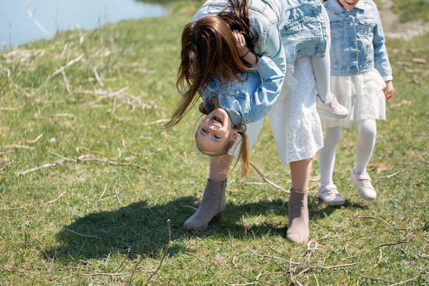 Mother and daughter have fun near a reservoir in the village - Fotoğraf, Görsel