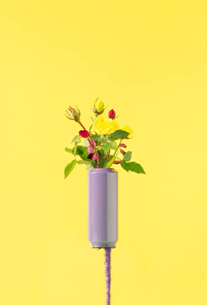 Blooming colorful flowers and spilling purple sand on a pastel yellow background. Minimal spring concept. Creative Valentine's day or woman idea. - Foto, imagen