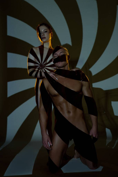 Nude female and male models in spiral shade - Fotó, kép