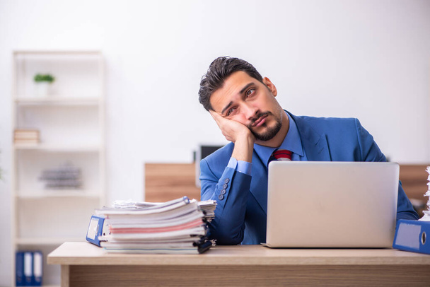 Young male employee unhappy with excessive work at workplace - Photo, Image