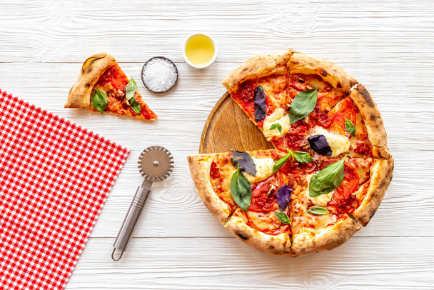 Pizza slices with tomatoes cheese and basil, top view - Foto, imagen