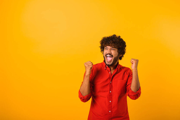 Extremely excited overjoyed man with beard shouting making yes gesture, amazed with his victory, triumph. Indoor studio shot isolated - Foto, immagini