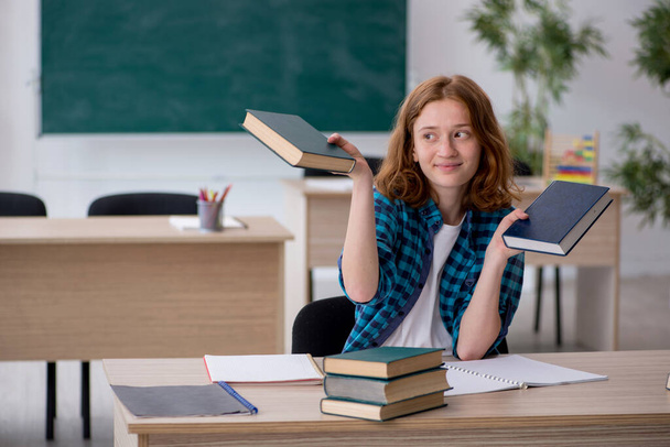 Young female student preparing for exam in the classroom - Photo, Image