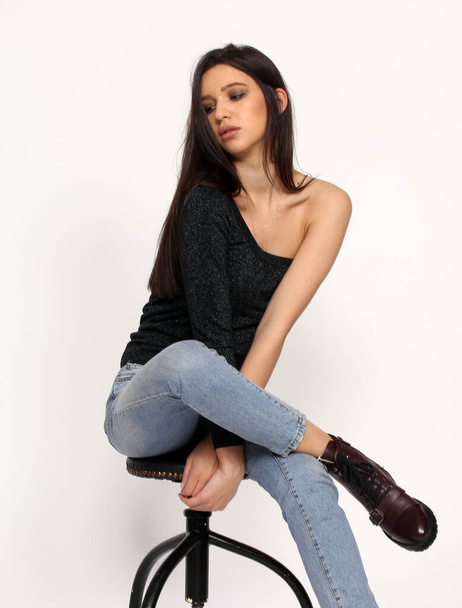 Beautiful, stylish brunette female model posing in studio on isolated background. Style, lifestyle, fashion concept. - Photo, image