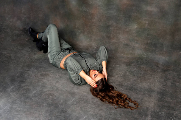 Beautiful brunette female model posing in studio on isolated background. Style, trends, fashion concept. - Valokuva, kuva