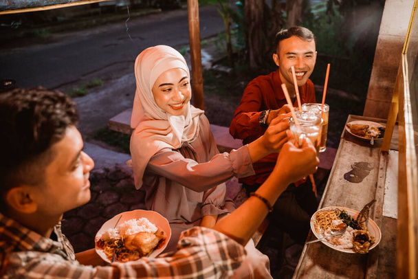 muslim asian friend cheering their glass for break fasting - Photo, Image