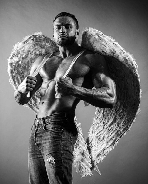 Muscular guy with angel wings and sexy torso. - Zdjęcie, obraz