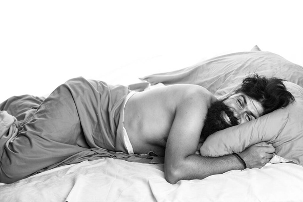 Young man sleeping in bed with pillows at home. Handsome man in bed. sleeper. Wake up Sleepy. - Foto, Imagen