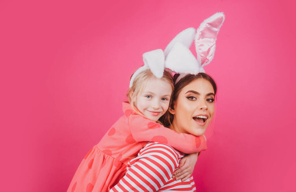 Happy easter family. Happy sister childhood concept. Girls bunny ears Funny little mother kids celebrate. Egg hunt traditional spring holiday. - Foto, Imagen