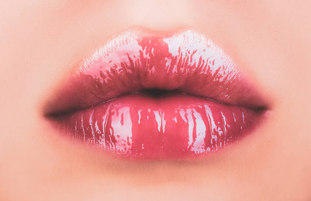 Sexy female lips with pink lipstick. Sensual womens open mouths. Red lip with glossy lipgloss. Seductive lips of a young woman. - Foto, immagini