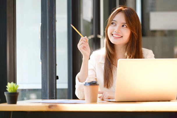 Happy businesswoman relaxing at office desk. - Photo, image