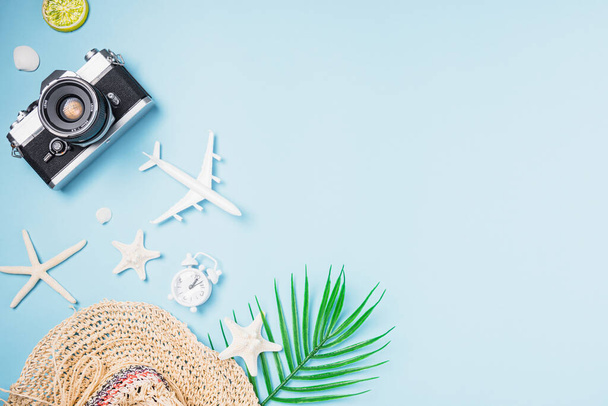 Flat lay top view mockup retro camera films, airplane, starfish, shells, hat traveler tropical accessories on a blue background with copy space, Business trip, and vacation summer travel concept - Foto, Imagem