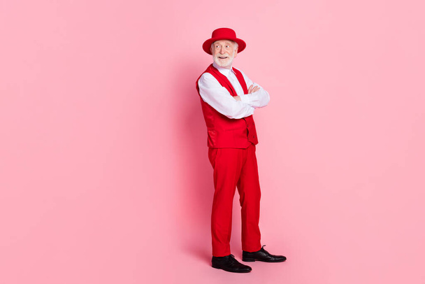 Full body profile side photo of aged man happy positive smile folded hands look empty space isolated over pink color background - Фото, зображення