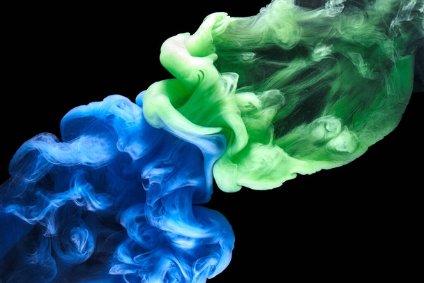 Blue green smoke on black ink background, colorful fog, abstract swirling ocean sea, acrylic paint pigment underwater - Photo, Image