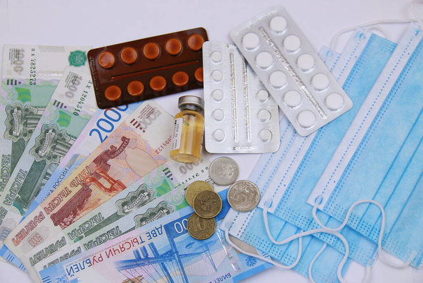 A cure for coronavirus. Different pills, syringe, antibiotic, mask and Russian mone - Фото, изображение