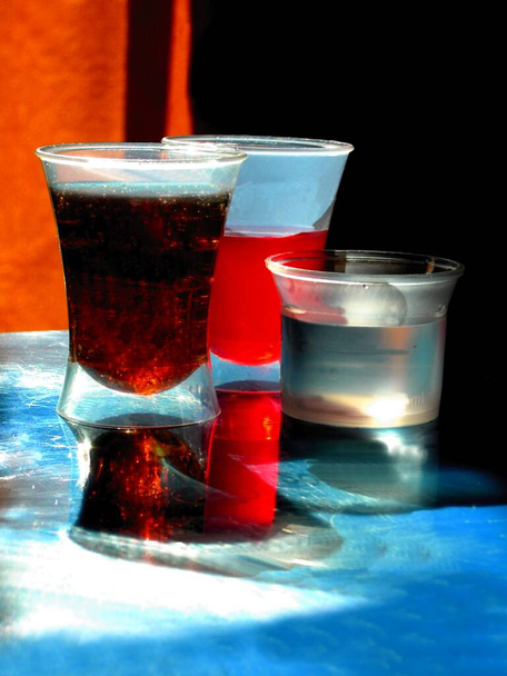 small transparent pot with colorful various drinks - Foto, Imagem