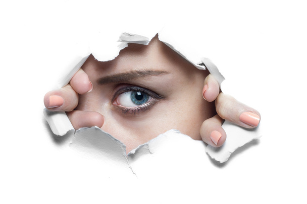Woman Looking Through Ripped Paper Hole - Foto, imagen