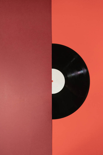Vinyl record on a red background - Fotoğraf, Görsel