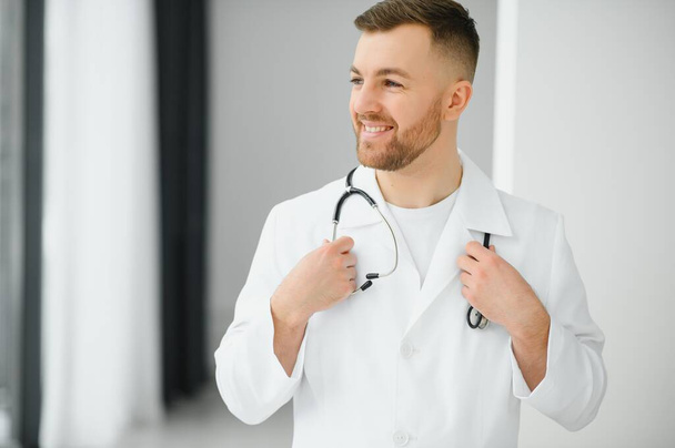 Young and confident male doctor portrait. Successful doctor career concept. - Foto, immagini