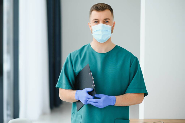 Portrait of male doctor wearing surgical mask is ready to help patients with coronavirus or covid virus. - Foto, imagen