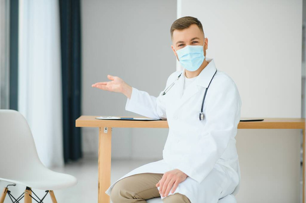 Portrait of male doctor wearing surgical mask is ready to help patients with coronavirus or covid virus. - Photo, Image