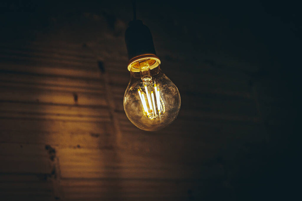 Led light bulb, low consumption, in a dark room - Φωτογραφία, εικόνα