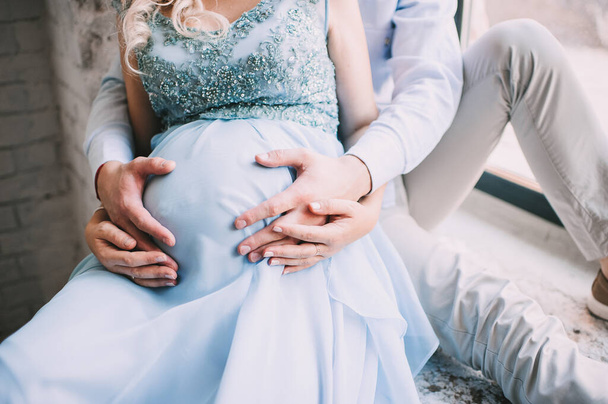 young couple gently touch the tummy of the expectant mother - Foto, immagini