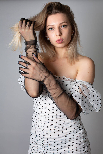 European woman with blonde hair and white skin isolated on dark grey in dress - Valokuva, kuva