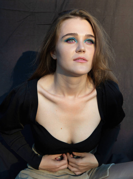 Young woman with white skin isolated on dark brown with deep neckline - Zdjęcie, obraz