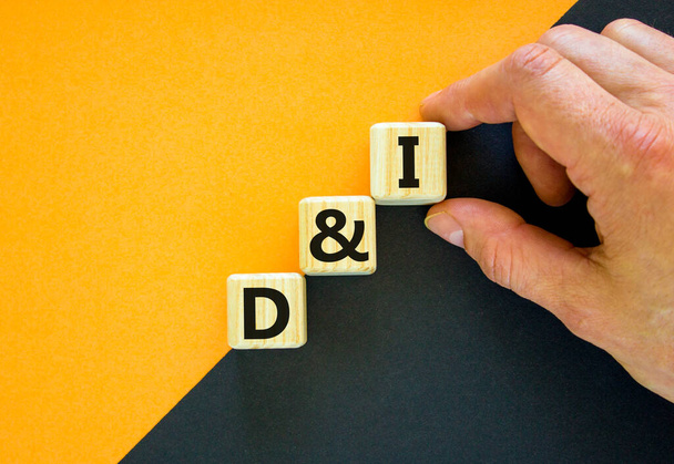D and I, Diversity and inclusion symbol. Concept words D and I, diversity and inclusion on wooden cubes on beautiful black and yellow background. Business, D and I, diversity and inclusion concept. - Zdjęcie, obraz