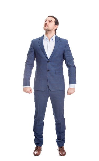 Determined businessman stands confident in a hero stance, full length portrait isolated on white background. Brave business person, leadership and motivation concept, shows ambition and strength - Φωτογραφία, εικόνα
