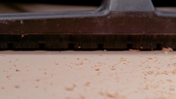 MACRO: Dust brush attachment of a vacuum cleaner sucks up particles of wood. - Footage, Video