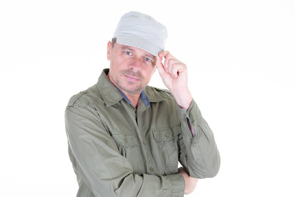 pohledný muž středního věku složené paže zkřížené a čepice na bílém pozadí - Fotografie, Obrázek