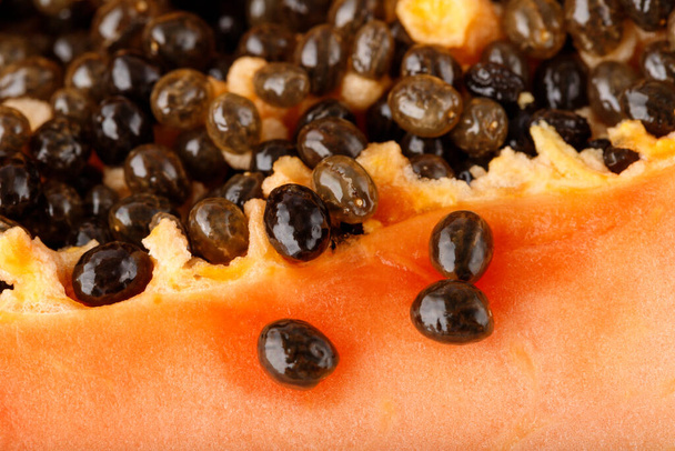 Papaya, Pawpaw, Tree melon pips seeds on orange fruit pulp (Carica papaya L.) - 写真・画像