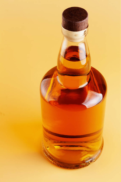 Brandy bottle on a light colored background - Foto, afbeelding