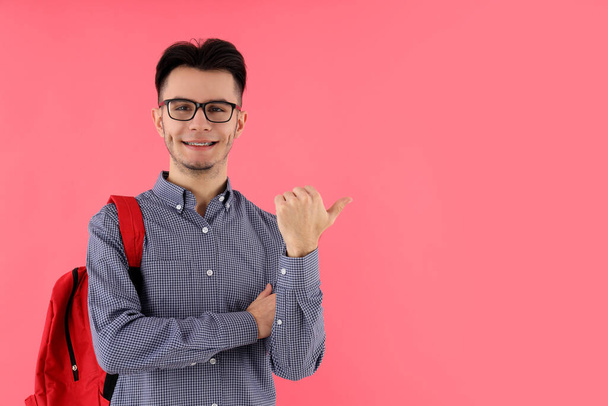 Male student with backpack on pink background - Foto, Bild