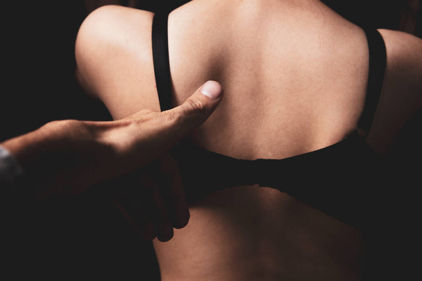 man sexually removes bra from woman - Fotografie, Obrázek